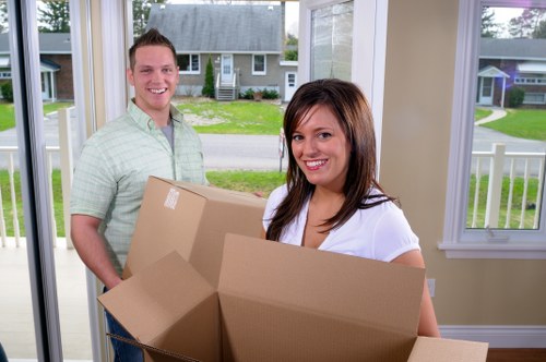 Local moving team organising boxes for a property in Watford