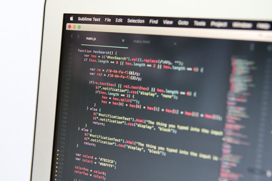 Close-up image of a computer screen displaying lines of HTML code, including tags such as <code><code></code>, <code>file://</code>, and <code>role="button"</code>, with a prominent wh